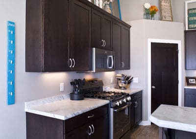 Dark wood cabinets in Volga, SD Custom Home with renovated kitchen by Shawn's Custom Homes